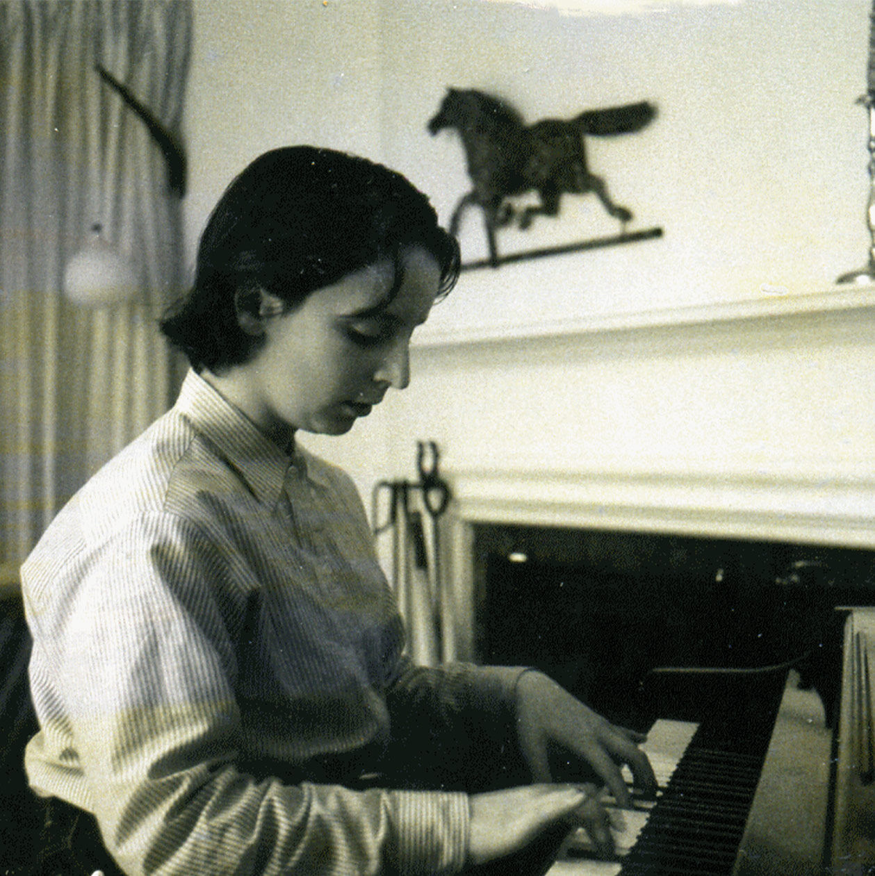 An old photograph of the author playing the piano